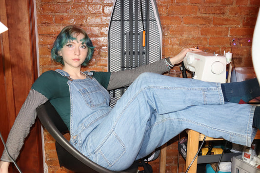 Image of Willow lounging nonchalantly at her workstation, looking very professional